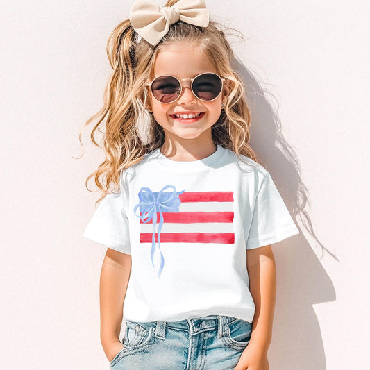 Girls Fourth July Shirt Watercolor American Flag Design Kids Patriotic Tee Blue Bow Accent Independence Day Outfit Youth Summer Celebration Wear Red White Blue Stripes Stars Pattern Comfortable Cotton Fabric Memorial Day Clothing Toddler