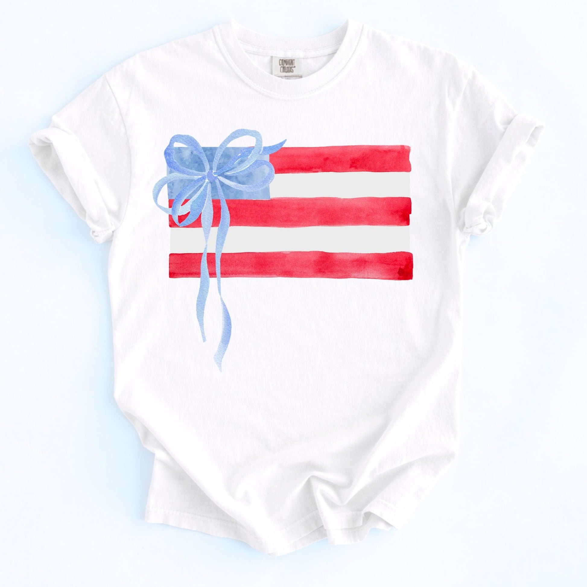 Patriotic Kids Shirt Girls Fourth July Outfit Watercolor American Flag Tee Blue Bow Accent Youth Independence Day Clothing Summer Celebration Shirt Red White Blue Design Stars Stripes Pattern Memorial Day Outfit Comfortable Cotton Toddler