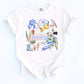 Nashville Shirt Women Music City Souvenir Tennessee Graphic Tee Volunteer State Pride Apparel Vintage Style Design Blue Iris Flowers Black Bear Cowboy Boots Banjo Symbols Cream Colored Casual Wear Perfect For Country Concerts Festival