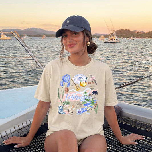 Graphic Tee Women Vintage Aesthetic Tennessee Pride Shirt Nashville Souvenir Apparel Hand Drawn Illustrations Blue Iris State Flowers Banjo Whiskey Glass Black Bear Symbols Cream Colored Casual Wear Perfect Country Concert Outfit Southern