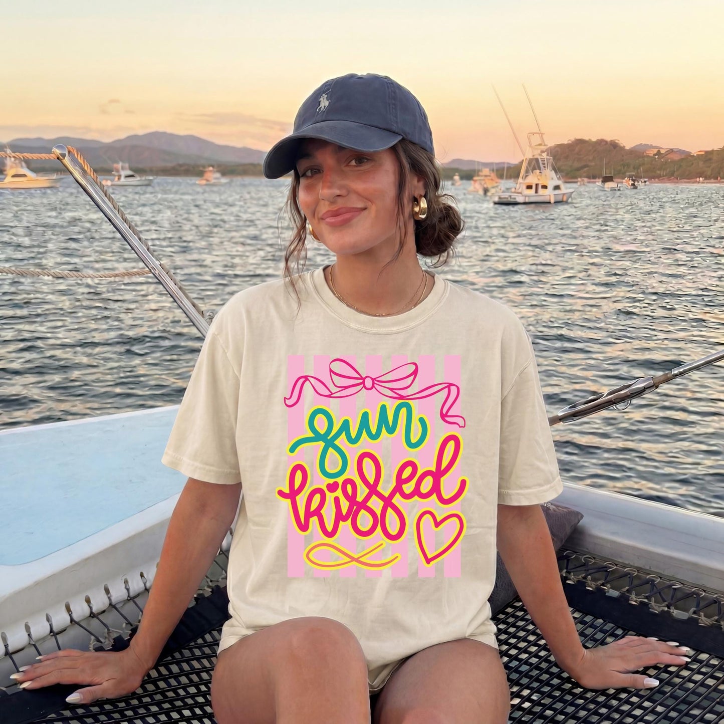 Beach Graphic Tee Women Sun Kissed Vacation Shirt Preppy Feminine Style Colorful Retro Design Resort Wear Summer Outfit Comfortable Casual Clothing Pink Bow Graphics Spring Break Cruise Shirt Poolside Lounging Essential Travel Wear Trendy