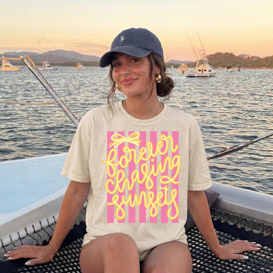 Retro Beach Vacation Tee Vintage Sunset Graphic Shirt Seventies Striped Design Forever Chasing Sunsets Text Yellow Script Lettering Pink Stripe Pattern Coastal Vibes Apparel Summer Travel Shirt Comfort Colors Cotton Soft Relaxed Fit Beach