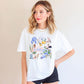 Tennessee Shirt Women Nashville Souvenir Graphic Tee Volunteer State Apparel Cream Colored Cotton Blend Vintage Inspired Design Blue Iris Flowers Banjo Music Symbols Black Bear Cowboy Boots Perfect Nashville Trip Souvenir Country Music