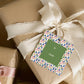Holiday Present Label Festive Design Christmas Gift Tag String Attached Colorful Tree Pattern Border Merry Christmas Lettering Green Center Panel Linen Cardstock Quality Natural Twine String Attachment Pre Punched Ready To Use Perfect